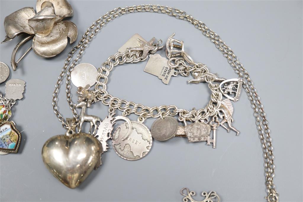 A white metal charm bracelet hung with enamel medallions, one other charm bracelet, marcasite watch and pendant etc.